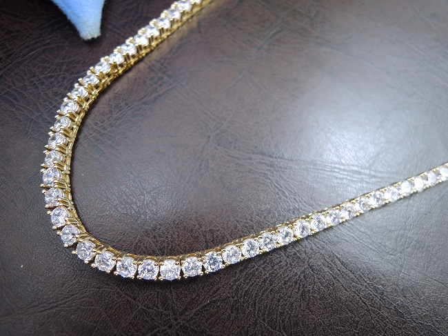 �S�[���h�e�j�X�l�b�N���X�@�L���[�r�b�N�W���R�j�A�E�A�N�Z�T���[